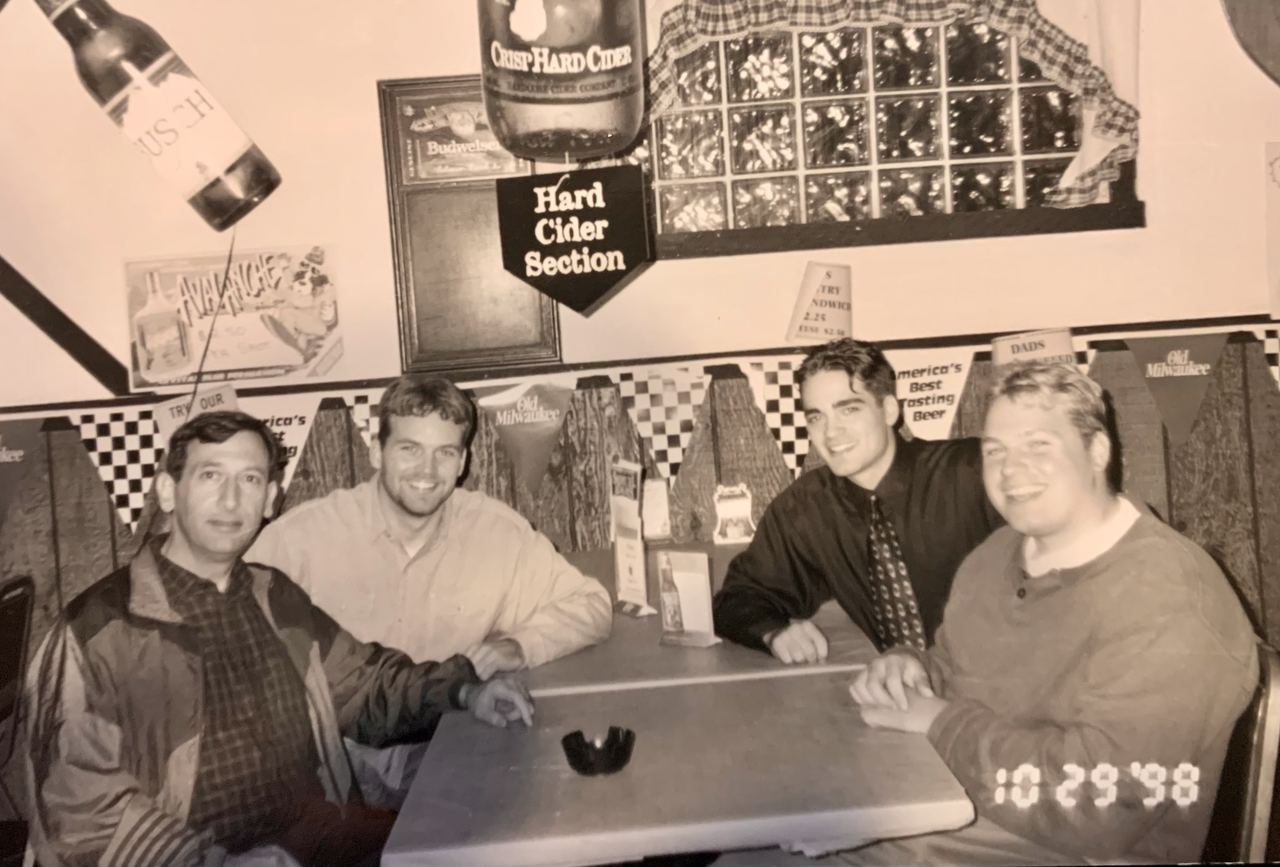 Byron Bitar with three of his students at a table, October 1998